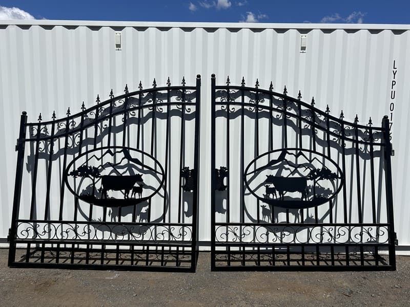 et of 2 Large Unused Wrought Iron Style Gates with Cow Scene, Each gate is 7ft wide, Height at High Side: 2.3m, Height at Low Side: 1.8m, Ma…