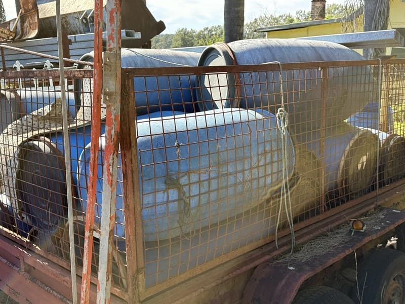 12 X 180 LITRE PLASTIC DRUMS. Trailer not included.