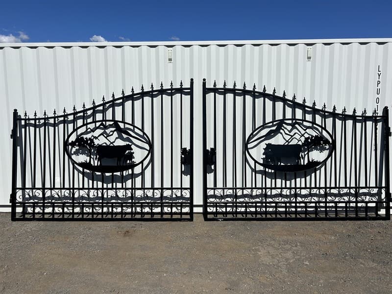 et of 2 Large Unused Wrought Iron Style Gates with Cow Scene, Each gate is 10ft wide, Height at High Side: 2.3m, Height at Low Side: 1.8m, M…
