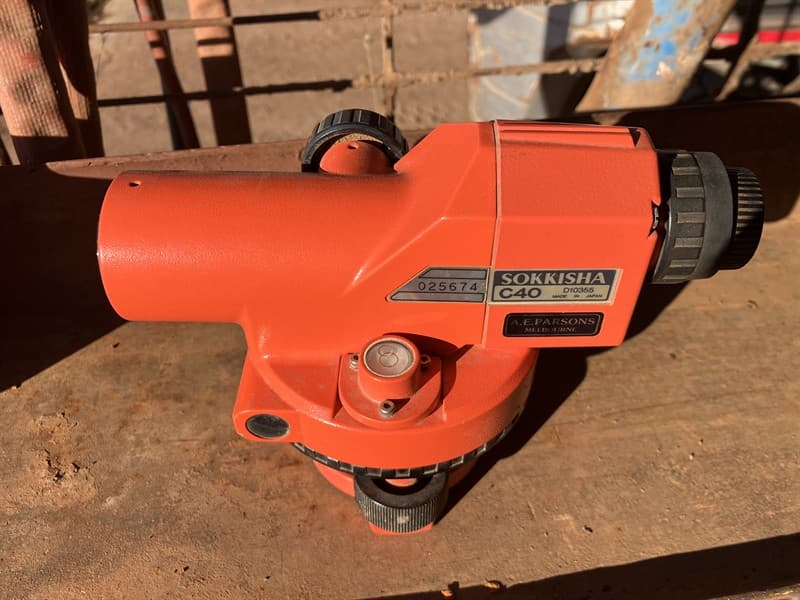 AUTO DUMPY SURVEYORS LEVEL. Suppleid with tripod stand and 5 metre staff. Carry case included. Located Trangie, NSW