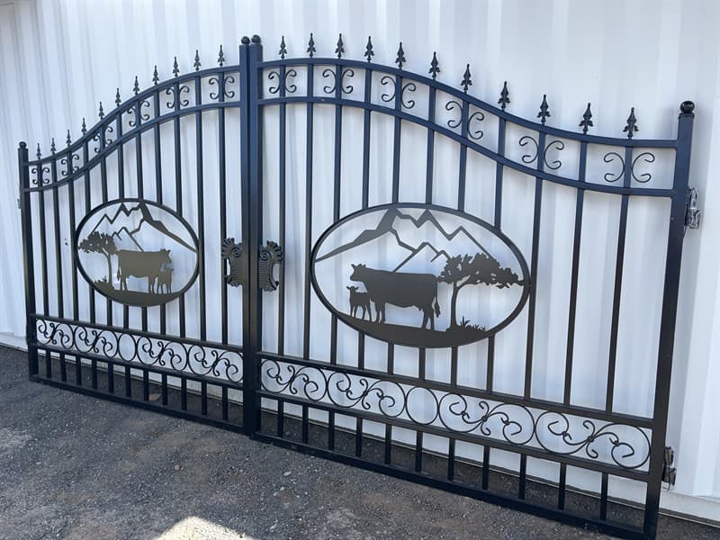 Set of 2 Large Unused Wrought Iron Style Gates with Cow Scene, Each gate is 8ft wide, Height at High Side: 2.3m, Height at Low Side: 1.8m, M…